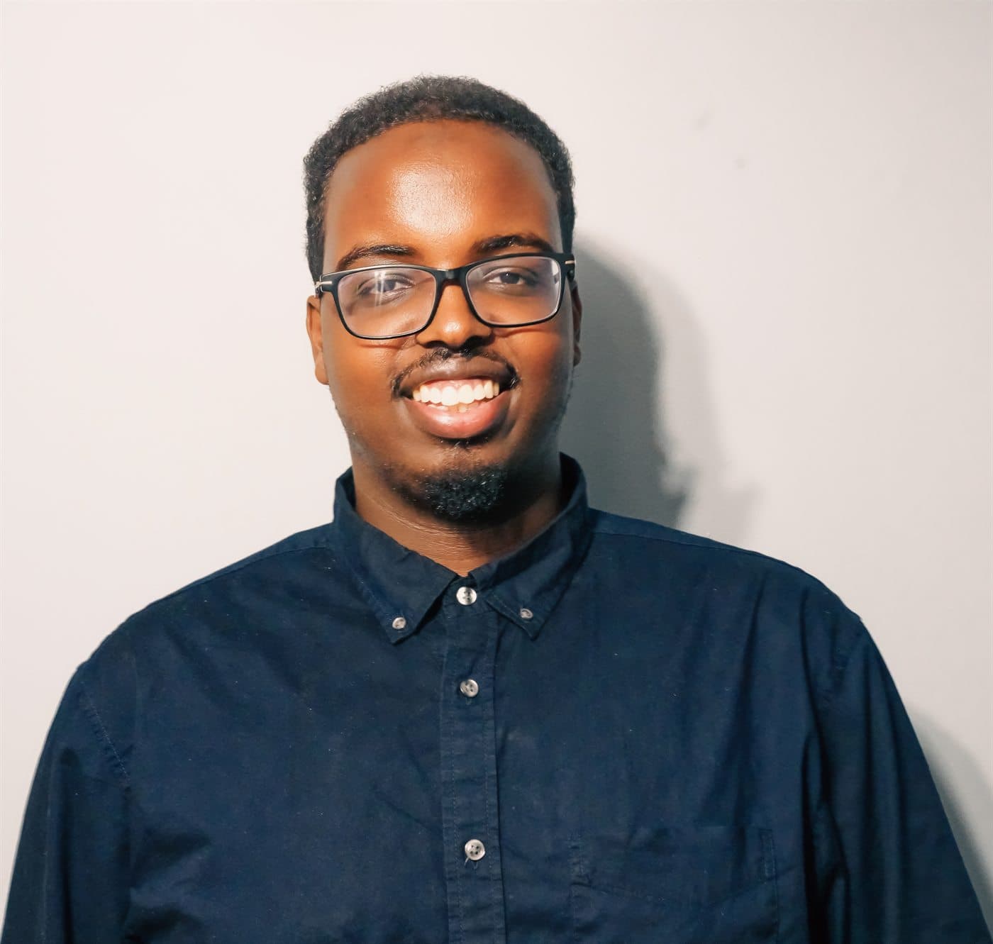 Jibriil Ali, MSW, RSW, smiling in a navy shirt.